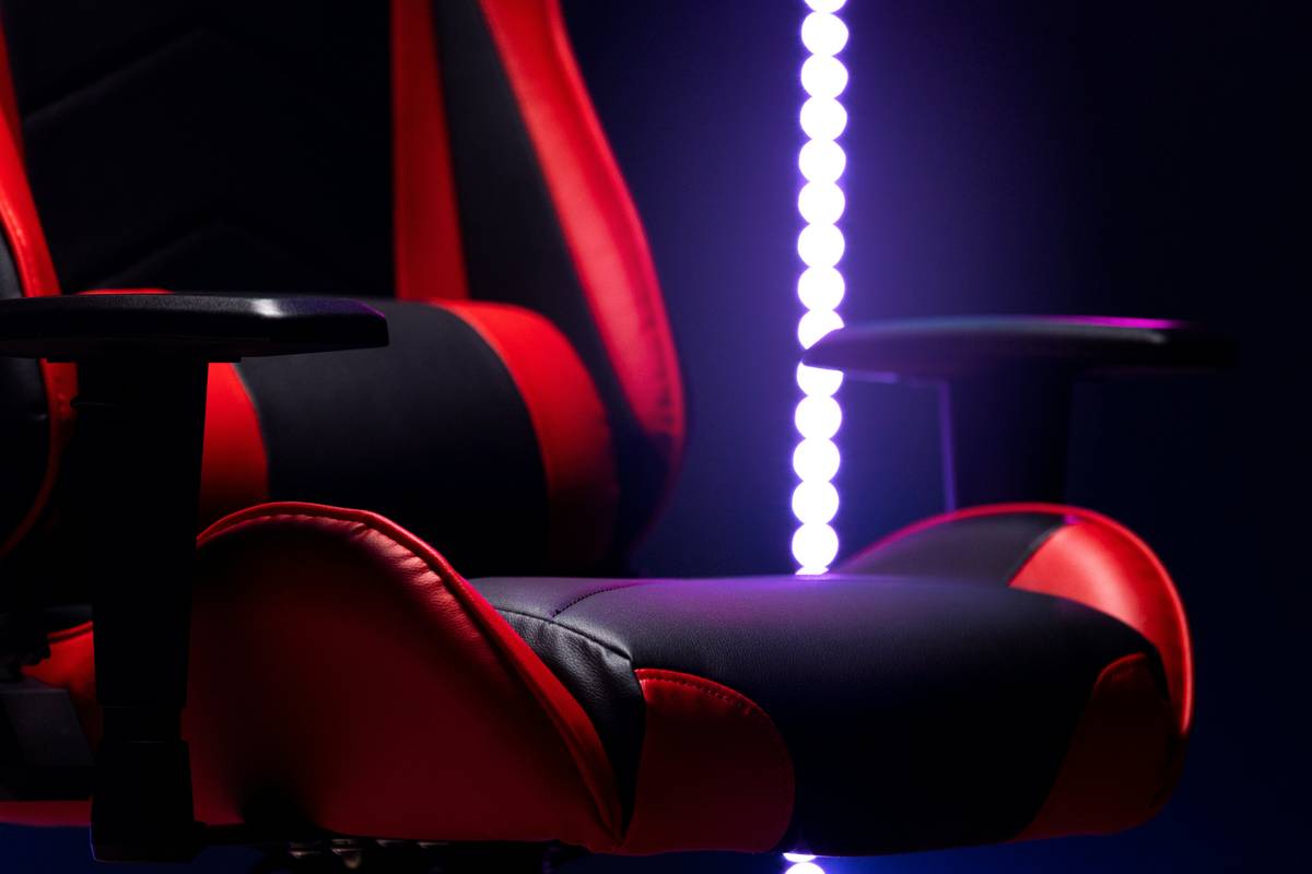 Gamer testing a premium chair with speakers during intense PC session